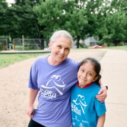 Girls on the run coach and girl smiling
